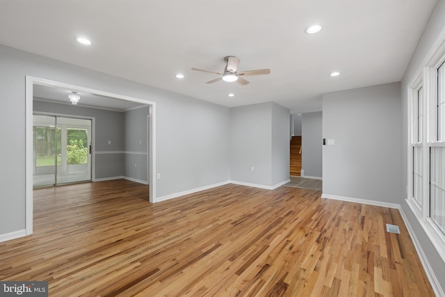 empty room featuring ceiling fan, light hardwood / wood-style flooring, and crown molding