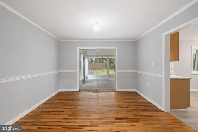 unfurnished room featuring light hardwood / wood-style flooring and ornamental molding