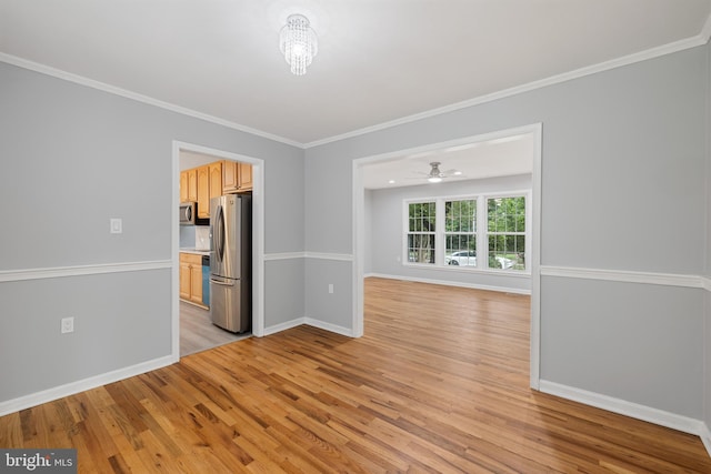 empty room with light wood-type flooring, ornamental molding, and ceiling fan