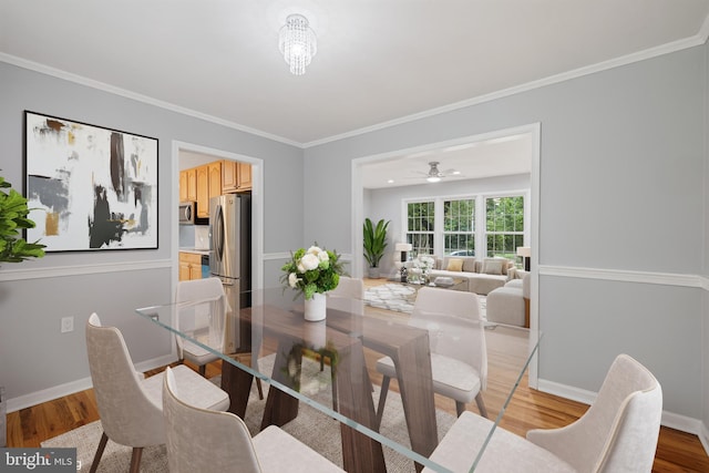 dining area with crown molding, ceiling fan, and light hardwood / wood-style flooring