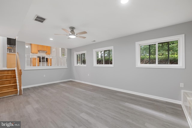 unfurnished room with light hardwood / wood-style flooring and ceiling fan