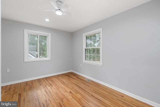 unfurnished room featuring light wood-type flooring and ceiling fan