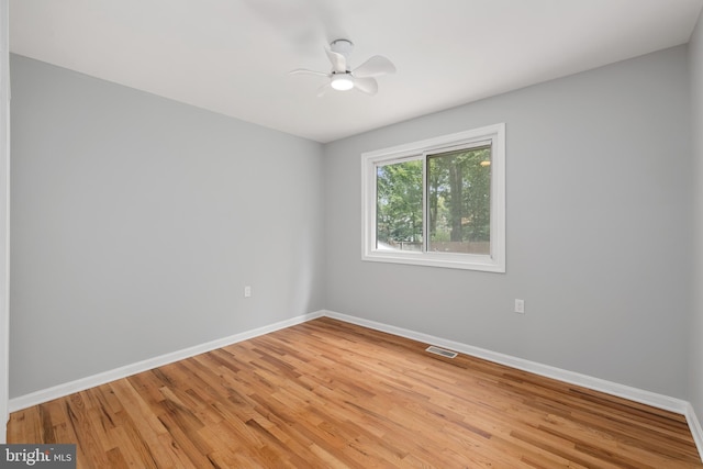 spare room featuring light hardwood / wood-style floors and ceiling fan