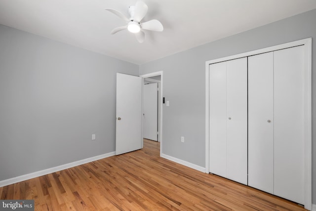 unfurnished bedroom featuring ceiling fan, a closet, and light hardwood / wood-style floors