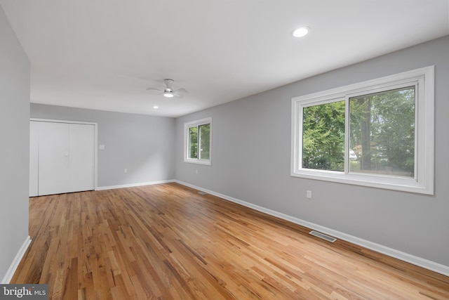 unfurnished room with ceiling fan and wood-type flooring