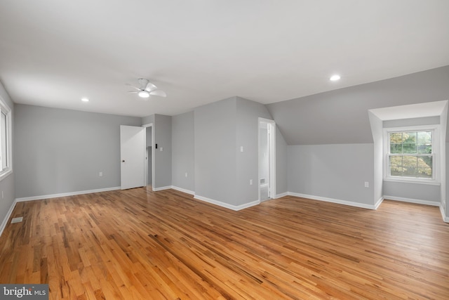 interior space featuring light hardwood / wood-style flooring, lofted ceiling, and ceiling fan