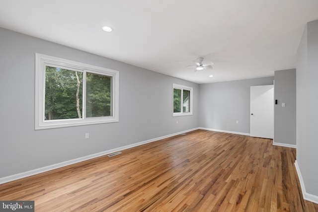 unfurnished room with ceiling fan and light hardwood / wood-style floors