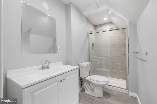 bathroom with vanity, hardwood / wood-style flooring, toilet, and an enclosed shower