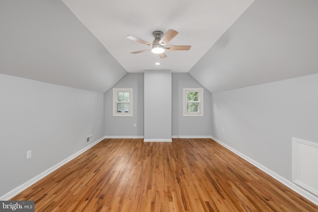 bonus room featuring light wood-type flooring, lofted ceiling, and ceiling fan