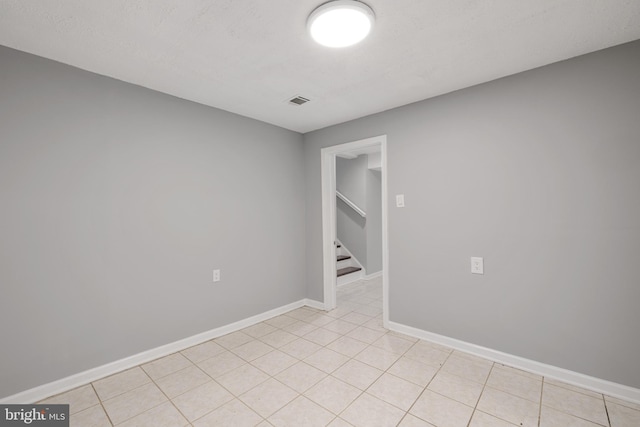 unfurnished room featuring light tile patterned flooring