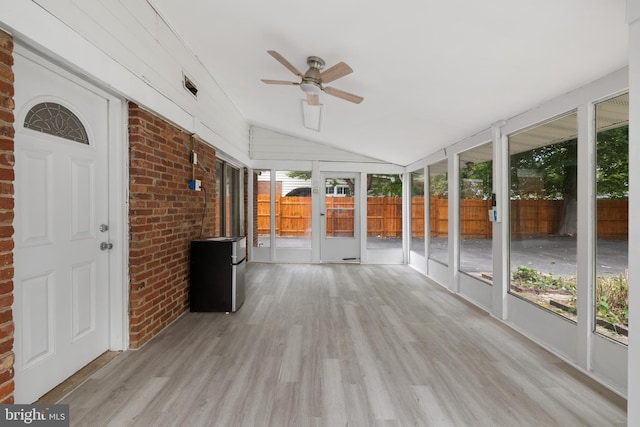 unfurnished sunroom featuring lofted ceiling and ceiling fan