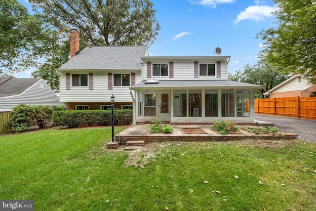 view of front of home with a patio and a front yard