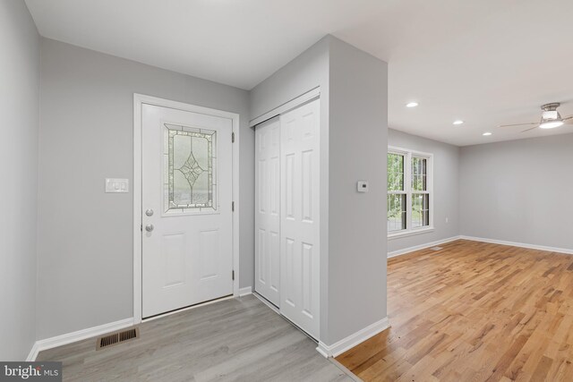 foyer with ceiling fan and light hardwood / wood-style floors