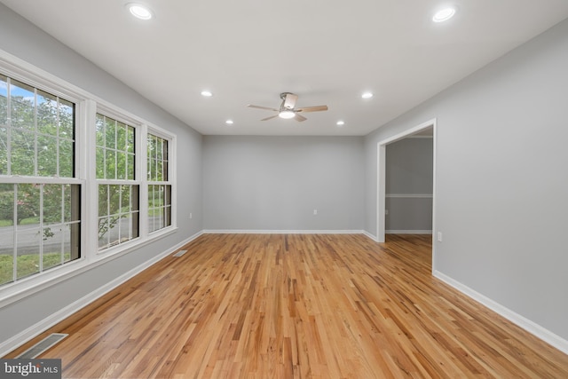 unfurnished room with light wood-type flooring and ceiling fan