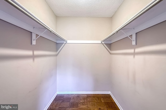 spacious closet with parquet floors