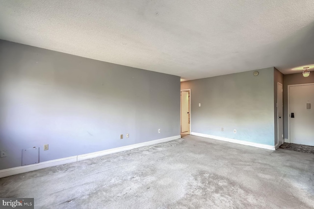 unfurnished room with light carpet and a textured ceiling