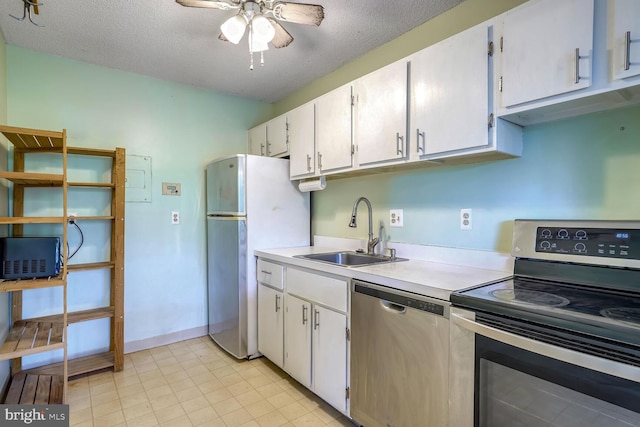 kitchen with white cabinetry, stainless steel appliances, a textured ceiling, and sink