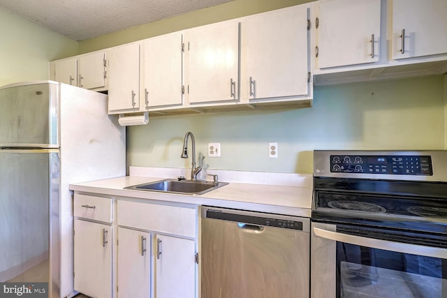 kitchen featuring white cabinetry, stainless steel appliances, a textured ceiling, and sink