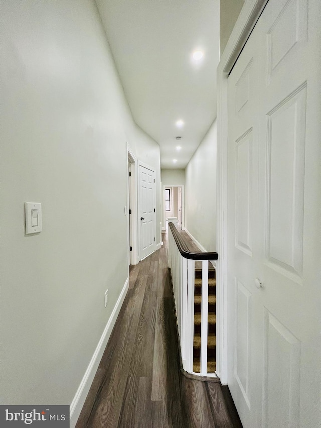 corridor with dark hardwood / wood-style floors