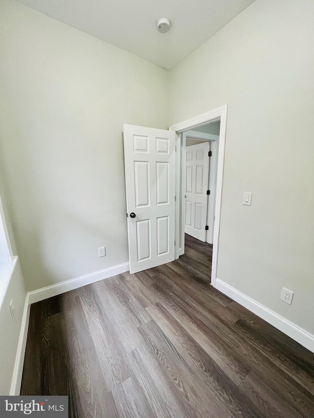 empty room with hardwood / wood-style flooring