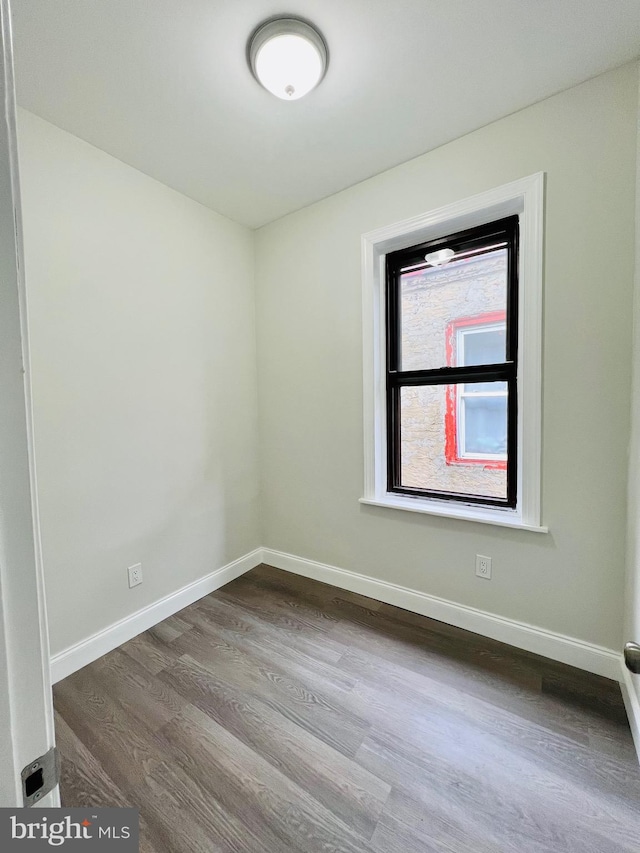 empty room with hardwood / wood-style floors