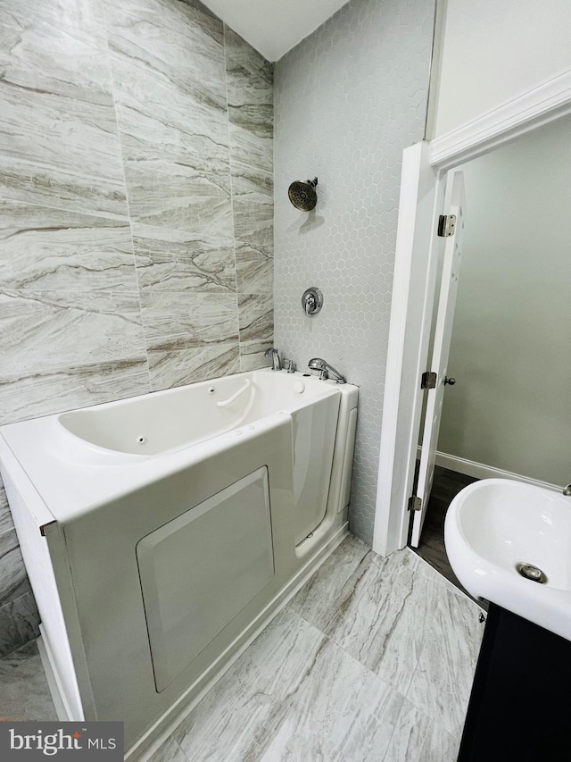 bathroom with a tub to relax in and vanity