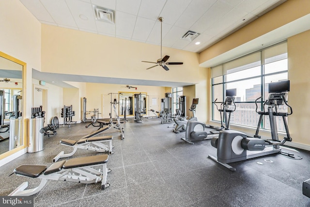 exercise room featuring a high ceiling and ceiling fan