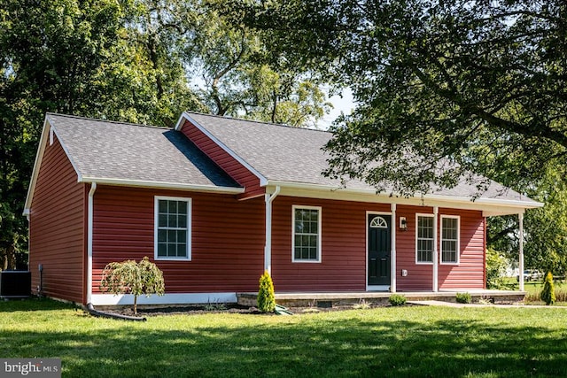 view of front of property featuring central air condition unit and a front yard