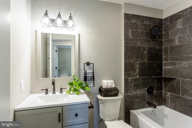 full bathroom featuring vanity, toilet, and tiled shower / bath combo