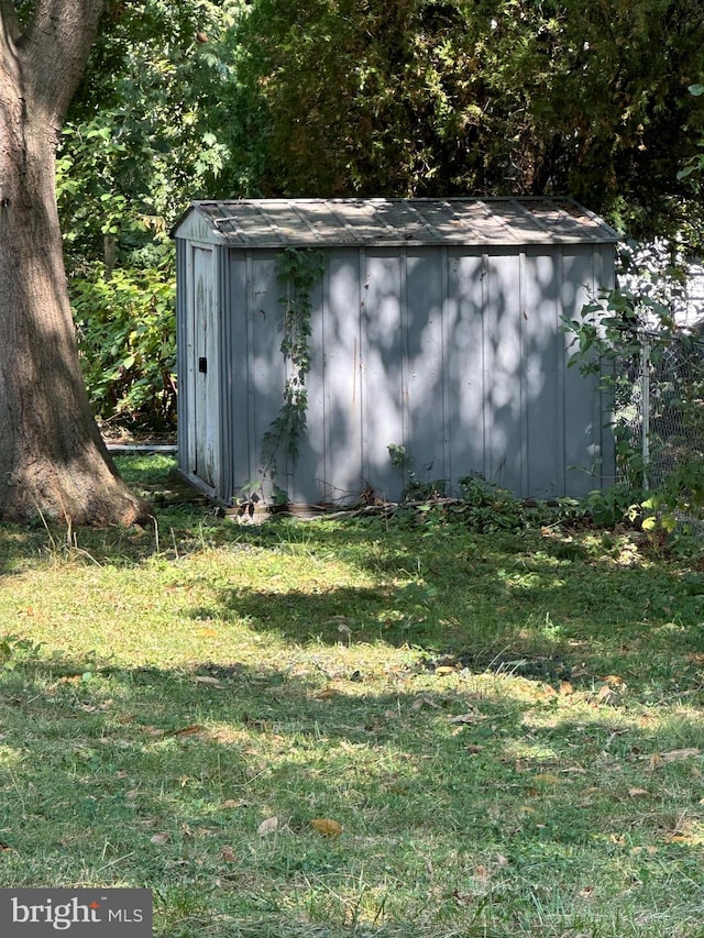 view of outbuilding with a lawn