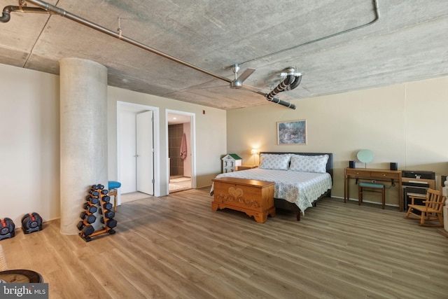 bedroom featuring hardwood / wood-style flooring and connected bathroom