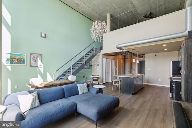 living room featuring a high ceiling, dark hardwood / wood-style flooring, and sink