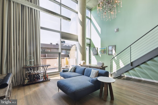 interior space featuring a notable chandelier, a high ceiling, and hardwood / wood-style floors