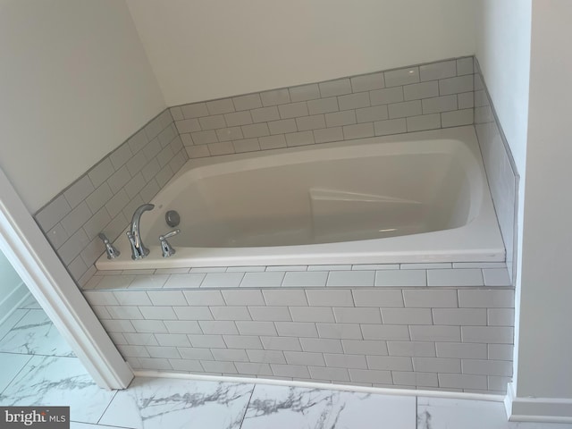 bathroom with a relaxing tiled tub