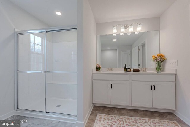 bathroom with a shower with door and vanity