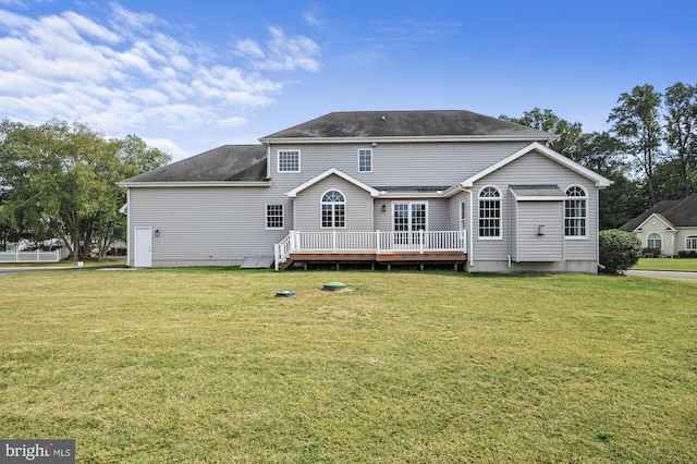 view of front facade with a deck and a front lawn