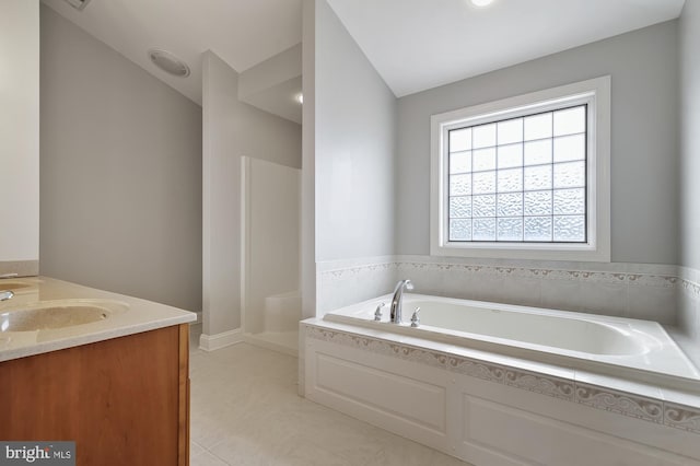 bathroom featuring vanity, tile patterned floors, and a bathtub