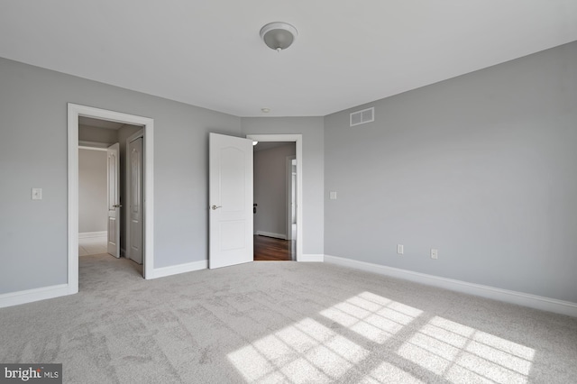 unfurnished bedroom with light colored carpet