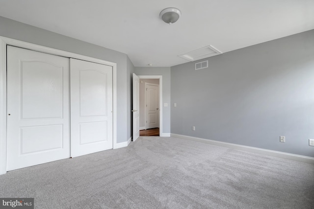 unfurnished bedroom featuring carpet and a closet