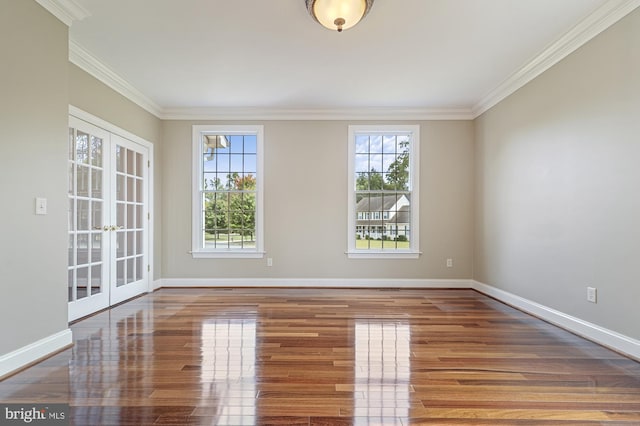 empty room with wood-type flooring, french doors, and crown molding