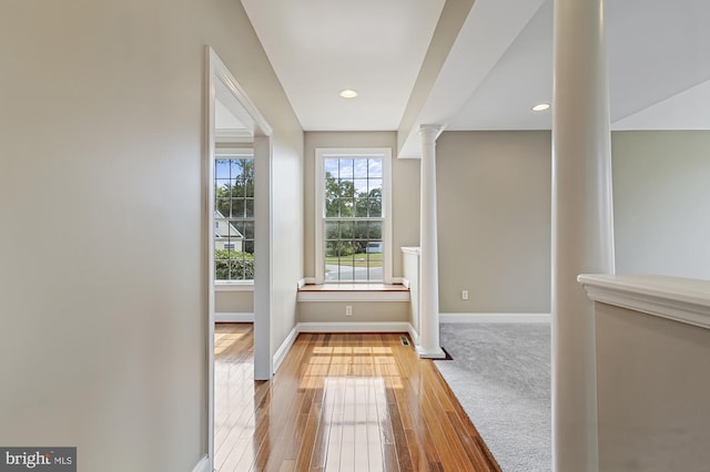 doorway featuring light hardwood / wood-style floors and ornate columns