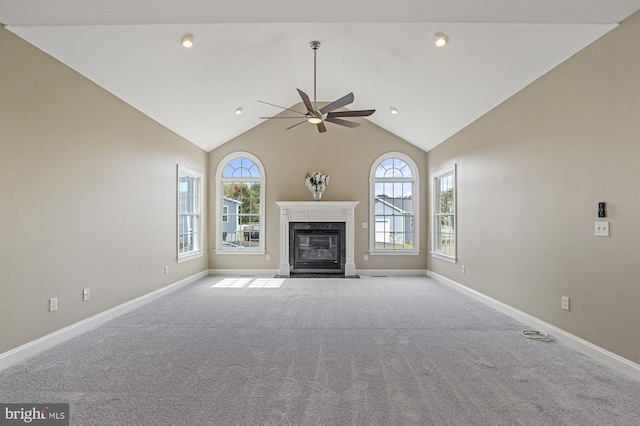 unfurnished living room with light carpet, ceiling fan, and high vaulted ceiling