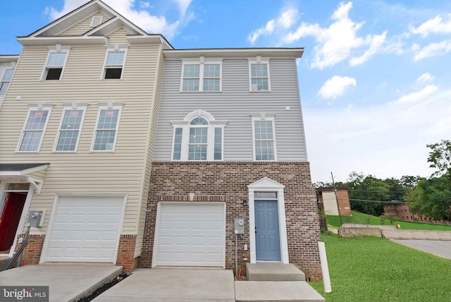 townhome / multi-family property with a garage, a front lawn, brick siding, and driveway