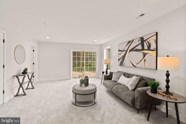 carpeted living room with recessed lighting, visible vents, and baseboards