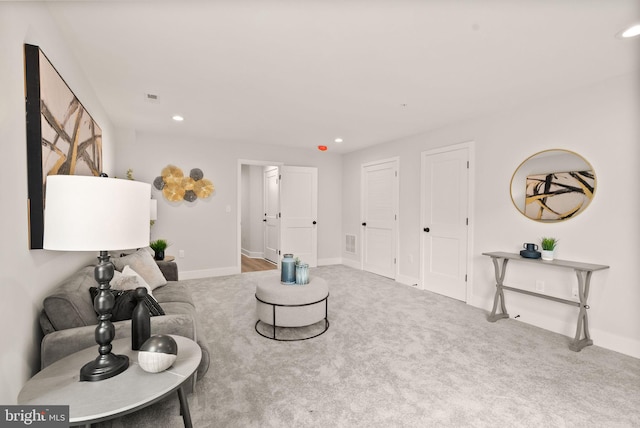 living area with recessed lighting, baseboards, carpet floors, and visible vents