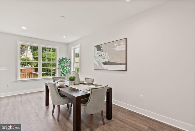 dining room featuring recessed lighting, wood finished floors, and baseboards