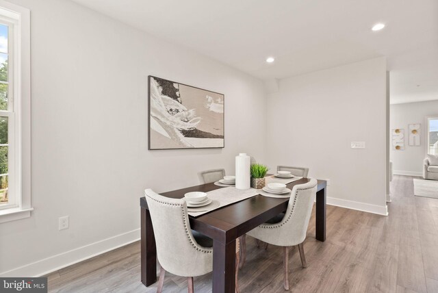 dining space with wood-type flooring