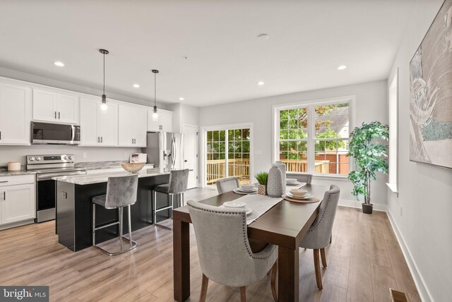 dining room with light wood-type flooring