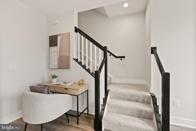 stairway with recessed lighting, baseboards, and wood finished floors