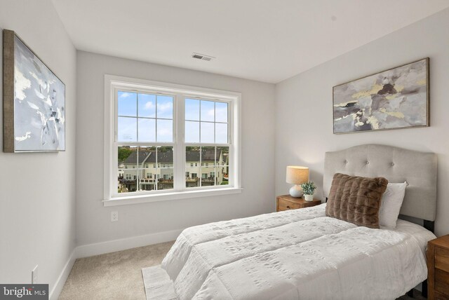 bedroom featuring baseboards, visible vents, and carpet floors